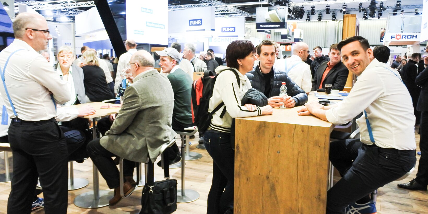 Laughing trade visitors in the lounge area with BUG employees