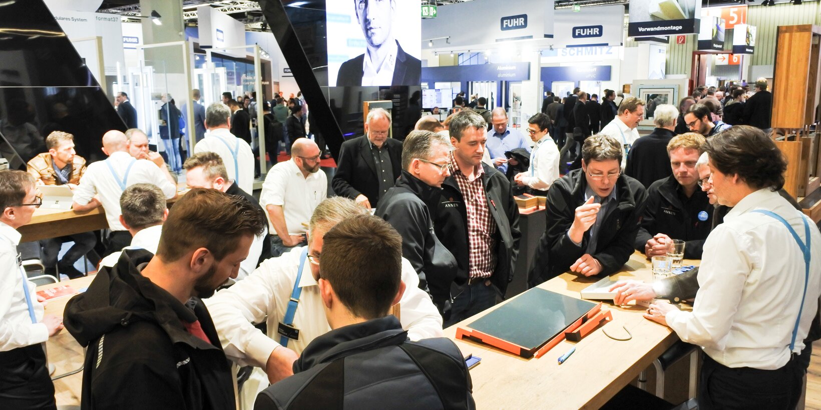 Stand visitors talking and interacting with BUG employees